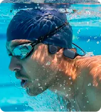 A man swimming wearing Walla Sound Beat bone conduction headphones
