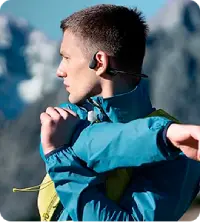 A person stretching wearing Walla Sound Beat bone conduction headphones